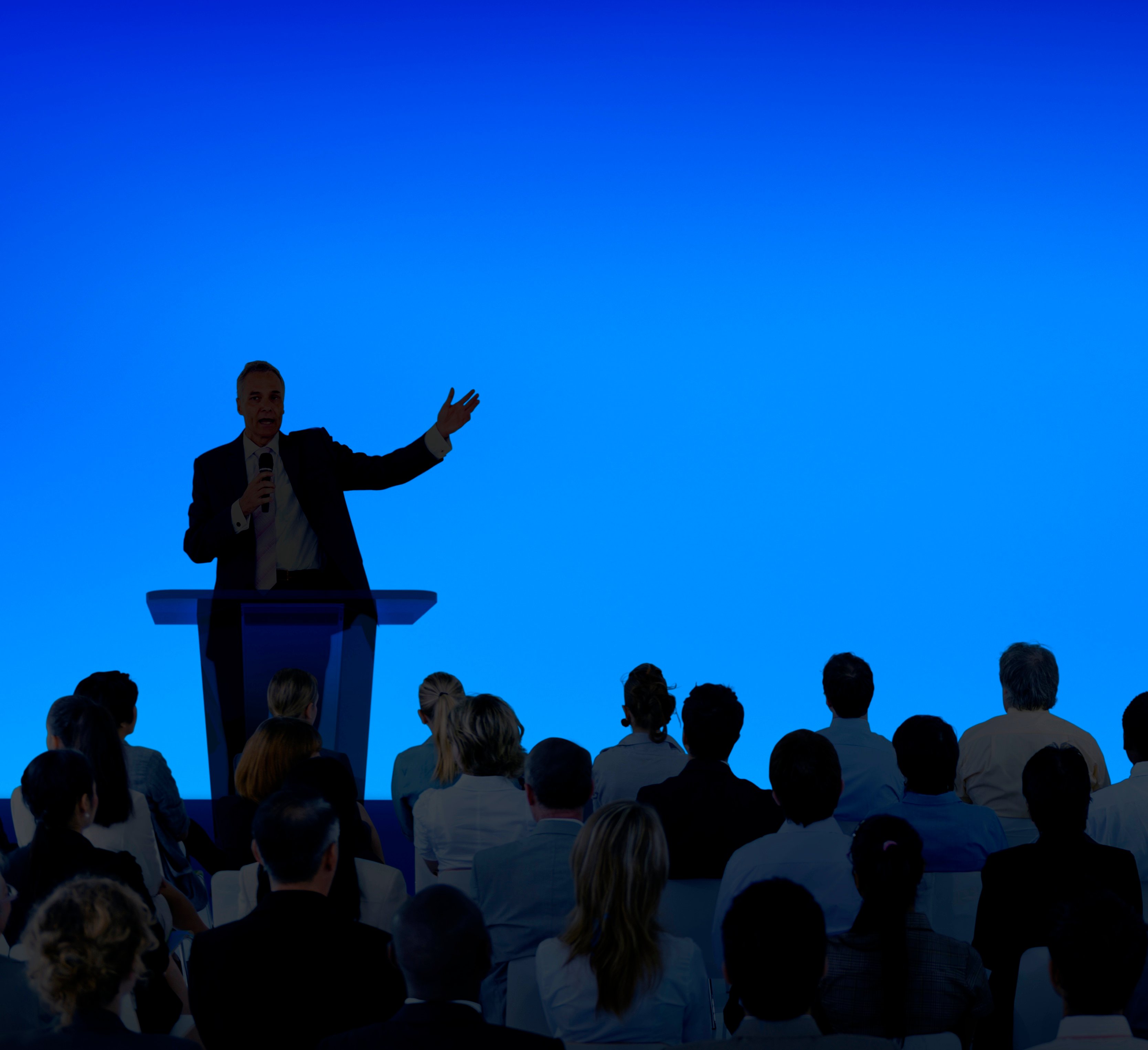 corporate-businessman-giving-presentation-large-audience-1